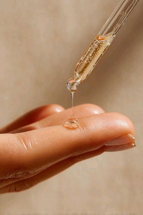 Serum dropper over a hand